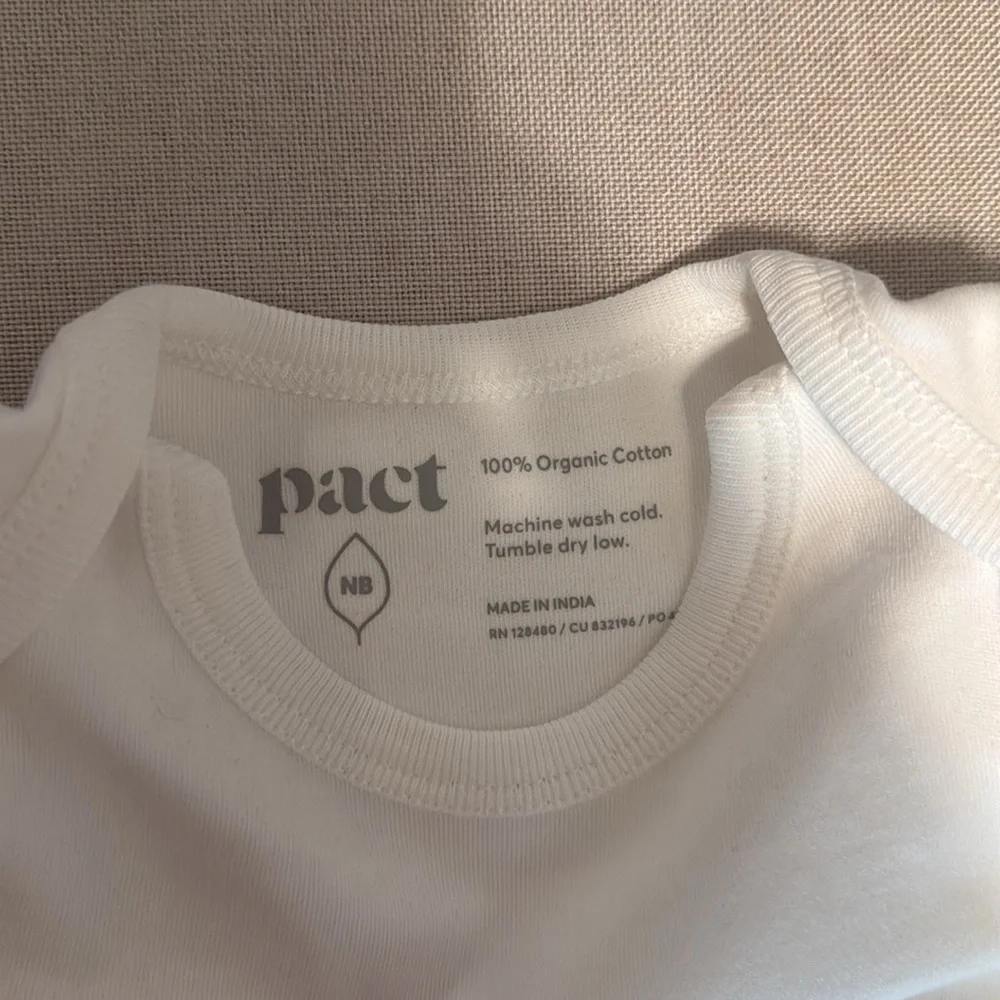 Pact newborn onesie